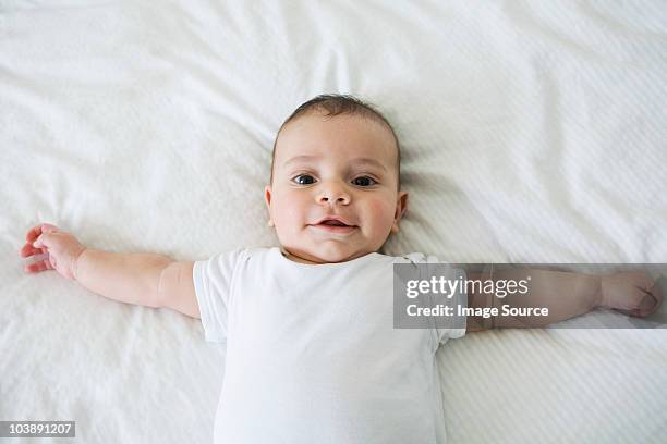 baby boy lying on back - supino foto e immagini stock