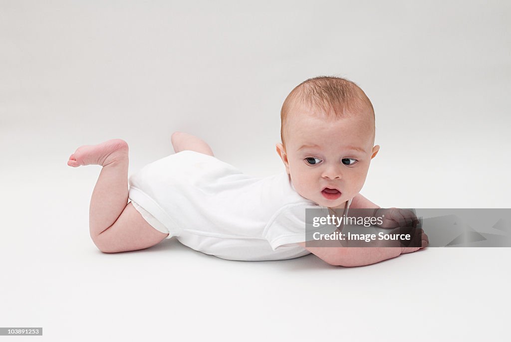 Portrait of a baby boy lying on his front