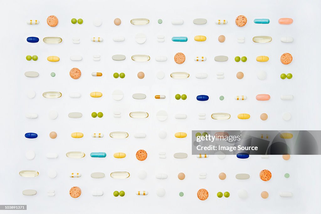 Rows of pills on white background
