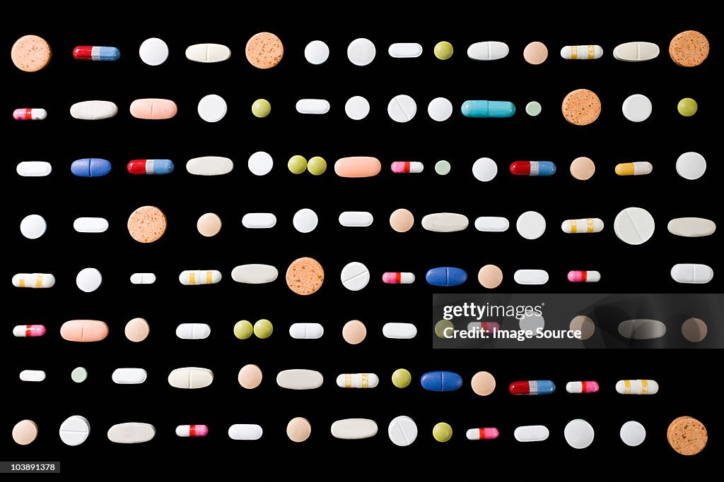 Rows of pills on black background