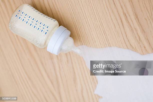 milk spilling from baby bottle - muttermilch stock-fotos und bilder
