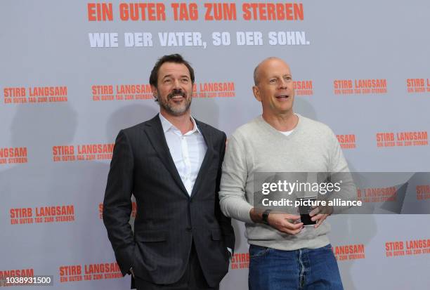 German actor Sebastian Koch and American actor Bruce Willis pose during a photocall for his new movie "A Good Day to Die Hard" in Berlin, Germany, 05...