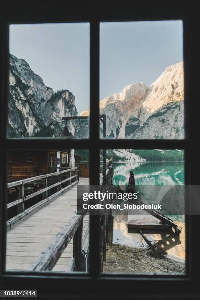 woman standing near the lake lago di braies  in dolomites - pragser wildsee stock pictures, royalty-free photos & images