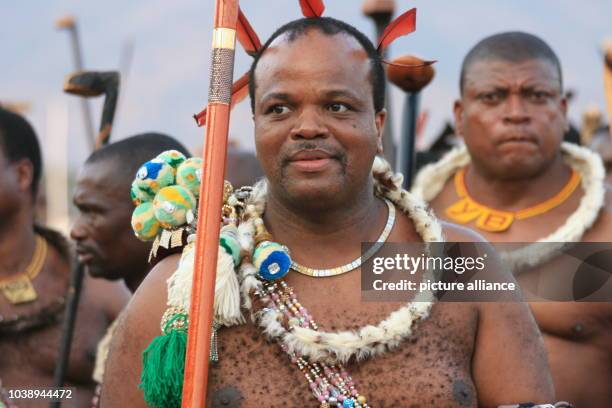 King Mswati III flanked by his entrourage watches the rehearsals for the Umhlanga dance in Ludzidzini, Swaziland, 30 August 2015. The traditional...