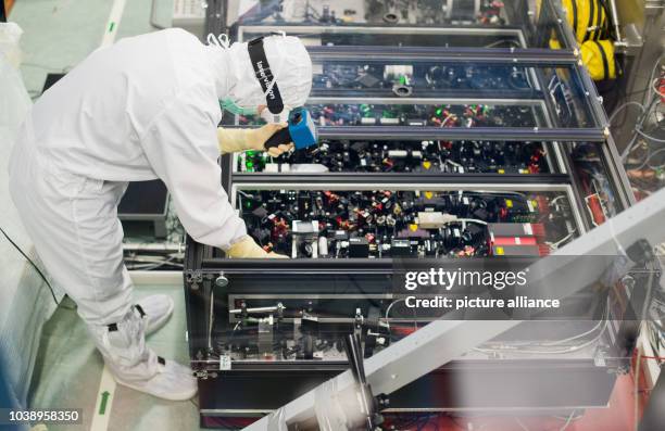 Academic assistant Emil Schreiber optimizes a subsystem in the GEO600 gravitational wave detector in Ruthe near Hanover, Germany, 11 February 2016....