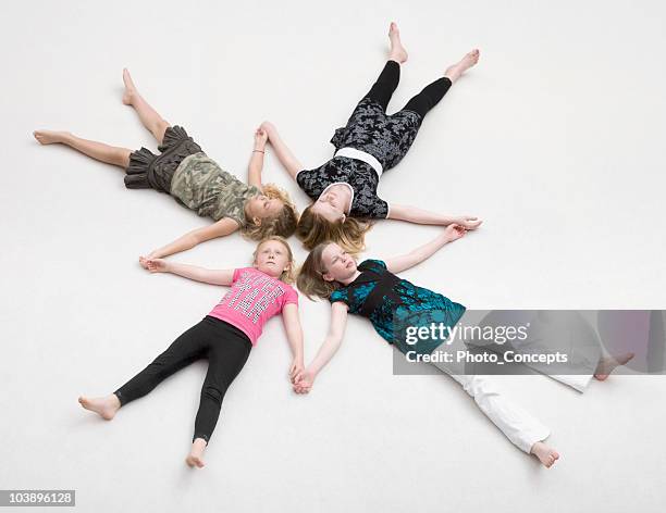 lying children, heads & arms touching. - children circle floor stock pictures, royalty-free photos & images