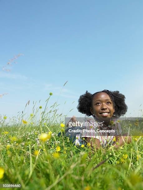 girl laying in open field - open day 9 stock pictures, royalty-free photos & images