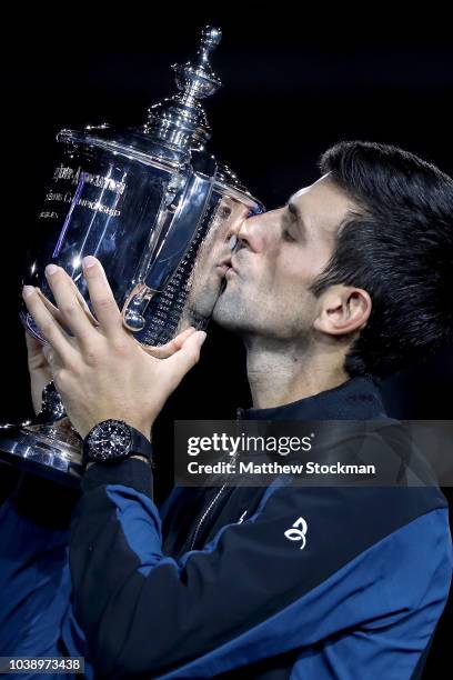 Novak Djokovic of Serbia kisses the trophy as he celebrates his win over Juan Martin Del Potro of Argentina during the men's final of the US Open at...