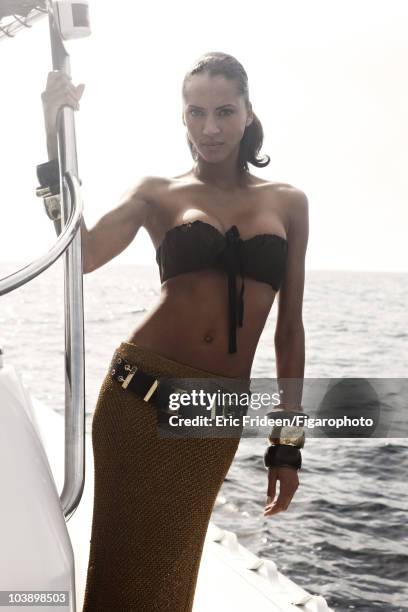 Model Noemi Lenoir at a James Bond inspired fashion session for Madame Figaro Magazine in 2009 in Corsica, France. Top by Prada, long skirt by Dries...