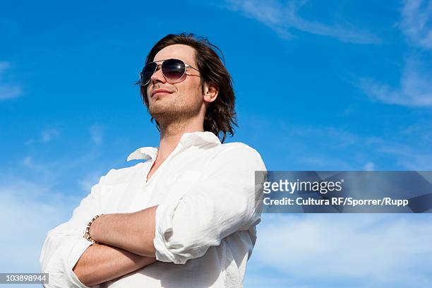 young man in front of blue sky - arrogant man stock pictures, royalty-free photos & images