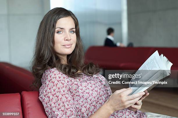 woman reading in airport lounge - blagnac stock pictures, royalty-free photos & images