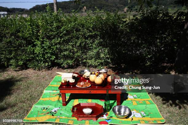 Memorial service table is prepared in front of a barbed wire fence during a ceremony to mark the Chuseok, the Korean Thanksgiving Day, at the...