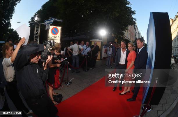 Actor Maximilian Brueckner , ARD Degeto CEO Christine Strobl and director Niels Willbrandt posing during the photo call on the red carpet on occasion...