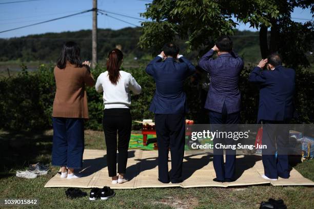 North Korean refugee Ko Ju-rak and his family members pay respects to their ancestors in North Korea during a ceremony to mark the Chuseok, the...