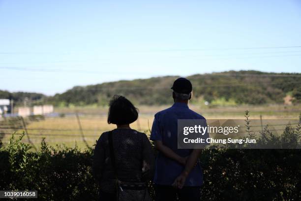 South Koreans look over a North side at the Imjingak Pavilion, near the demilitarized zone on September 24, 2018 in Paju, South Korea. Korean people...