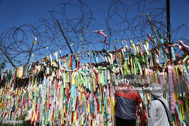 South Koreans hang ribbons wishing for reunification of the two Koreas on the wire fence at the Imjingak Pavilion, near the demilitarized zone...