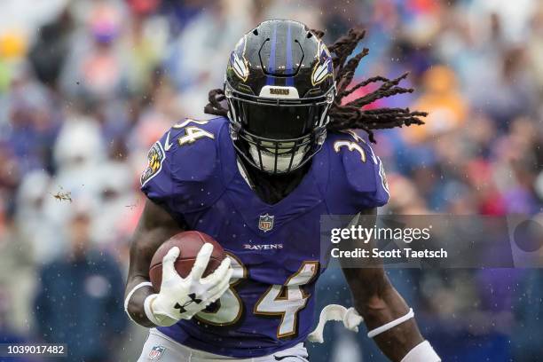 Alex Collins of the Baltimore Ravens rushes against the Denver Broncos during the first half at M&T Bank Stadium on September 23, 2018 in Baltimore,...