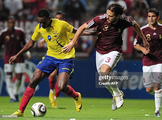 Ecuadorean footballer Jaime Ayovi vies for the ball with Venezuelan Jaime Bustamante, during a friendly match at the Metopolitano stadium in...