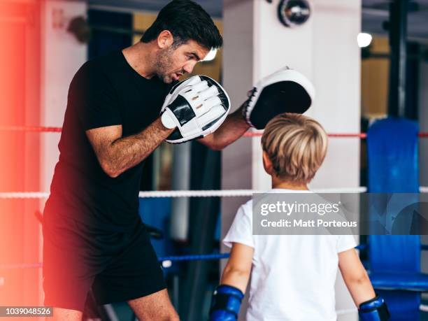 boxing mentor spars with kid - boxing coach stock pictures, royalty-free photos & images