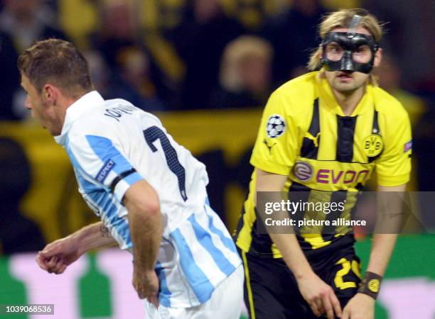 Malaga's Joaquin celebrates next to Dortmund's Marcel Schmelzer after scoring the 1-0 lead during the UEFA Champions League quarter final second leg...