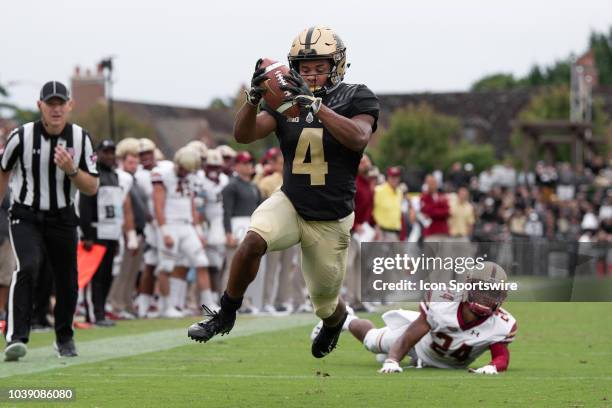 Purdue Boilermakers wide receiver Rondale Moore breaks away from Boston College Eagles defensive back Taj-Amir Torres for a 9-yard touchdown during...