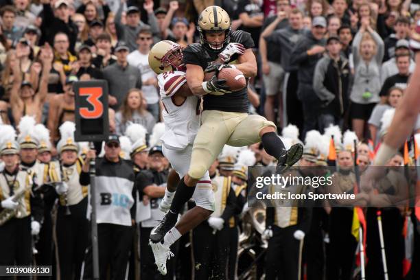 Boston College Eagles defensive back Taj-Amir Torres breaks up a pass in the end zone intended for Purdue Boilermakers tight end Brycen Hopkins...