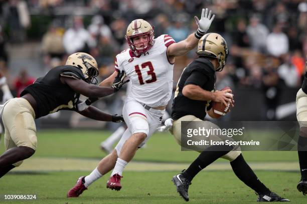 Boston College Eagles linebacker Connor Strachan gets pressure on Purdue Boilermakers quarterback David Blough during the college football game...