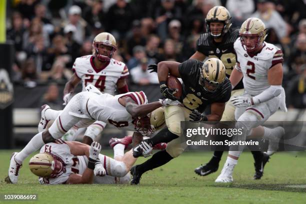 Boston College Eagles defensive back Will Harris trips up Purdue Boilermakers running back Markell Jones during the college football game between the...
