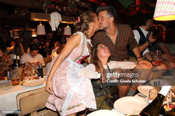 Annemarie Carpendale and her husband Wayne Carpendale kiss and Conny Lehmann during the 'Almauftrieb' as part of the Oktoberfest 2018 at Kaefer Tent...