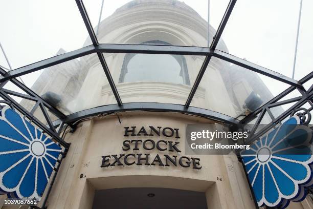 Signage for the Hanoi Stock Exchange is displayed outside the bourse in Hanoi, Vietnam, on Monday, Sept. 10, 2018. Vietnam has averaged economic...