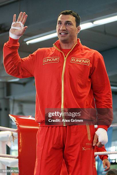 Ukrainian heavyweight champion Wladimir Klitschko waves as he arrives for a public training session at the local Mercedes Benz branch on September 8,...