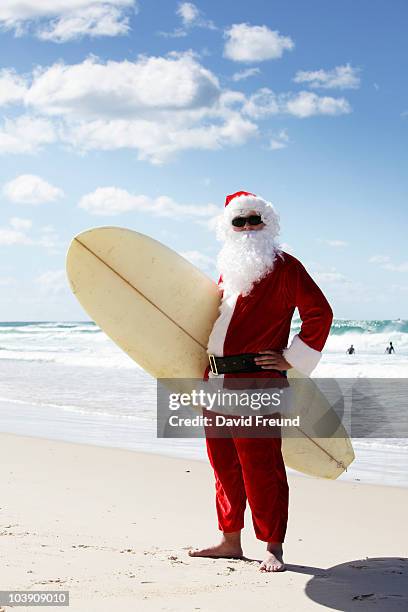 surfing santa - surfing santa stock pictures, royalty-free photos & images