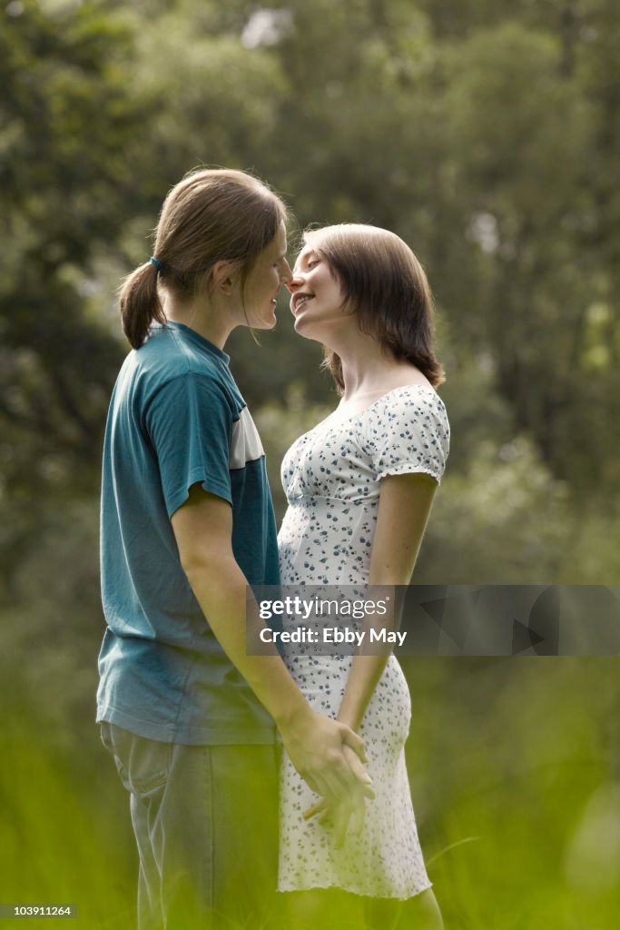 Young couple preparing to kiss, outdoors