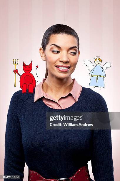 business woman with angel and devil on shoulder - angel devil stock-fotos und bilder