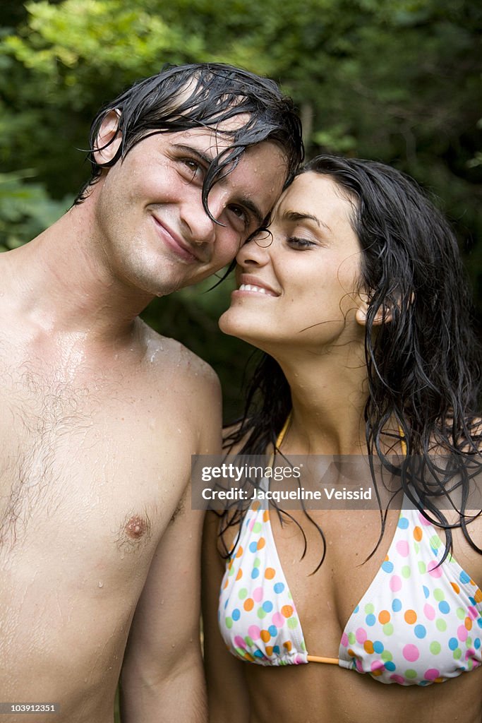 Woman and man smiling with wet hair