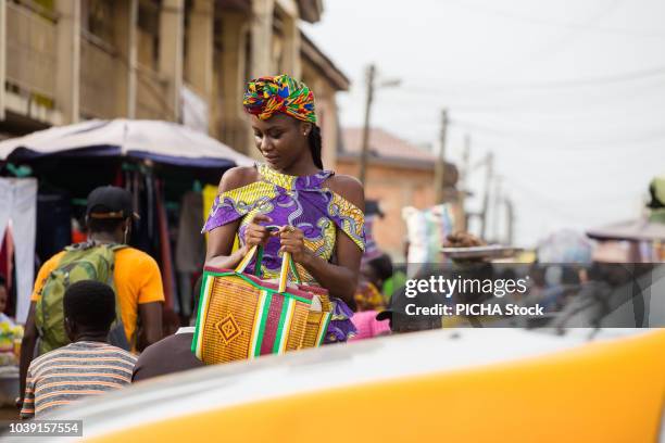 woman walking in the market - ghana woman stock pictures, royalty-free photos & images