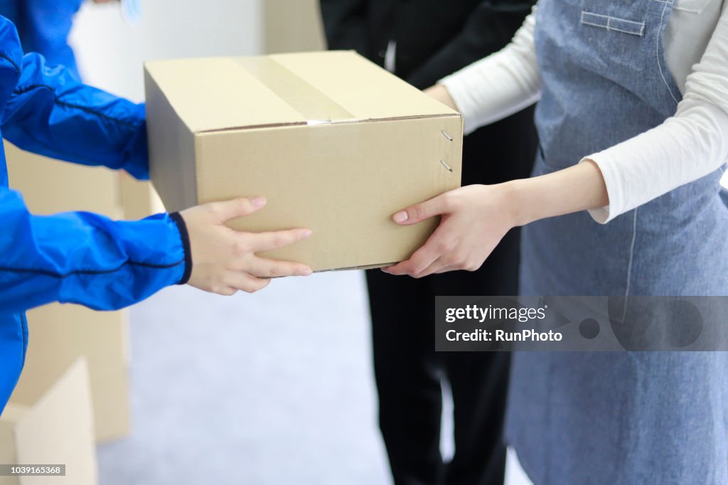 Delivery man delivering box to woman
