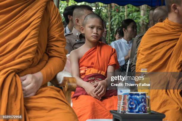 Mongkol Boonpiam a trainee in the Wild Boars football team attends a Buddhist ceremony at the entrance of Tham Luang cave. With 11 of his companions,...