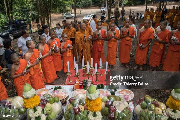 Twelve of the 13 members of the football team Wild Boars attend a Buddhist ceremony at the entrance of Tham Luang cave. They were ordained as novices...
