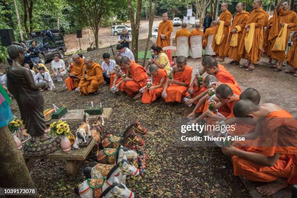 Twelve of the 13 members of the football team Wild Boars purify the soil in front of a statue of a princess believed to inhabit the Tham Luang cave...