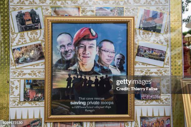 Mockup movie poster showing faces of Thai and foreign heroes hangs at a picture exhibition in a Mae Sai temple. Twelve boys, members of the football...