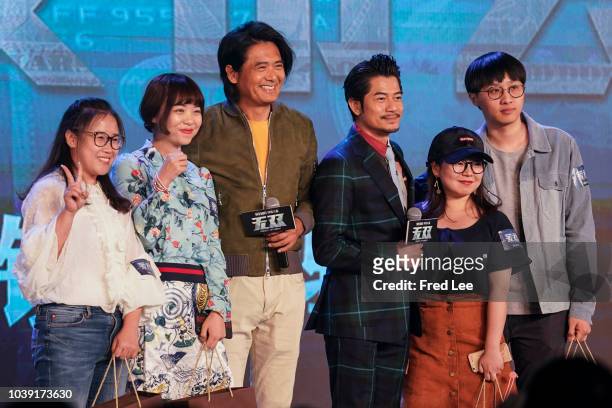 Hong Kong actor Chow Yun fat and Aaron Kwok take a seflie with a fan during Film 'Project Gutenberg' Premiere on September 24, 2018 in Beijing, China.