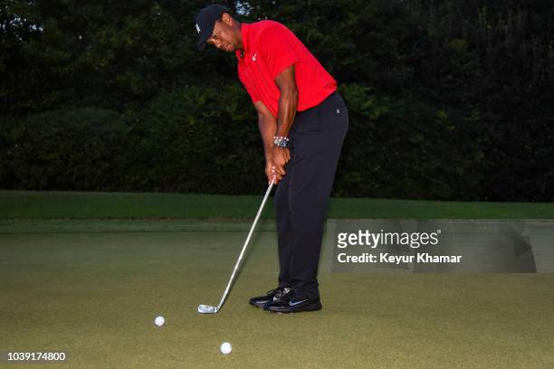 Tiger Woods putts with the Calamity Jane putter trophy following his two stroke victory during the final round of the TOUR Championship, the final...