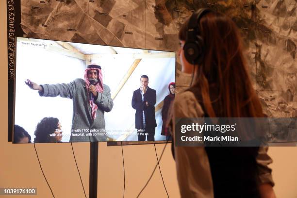 Woman views a video piece by artist Forensic Architecture during the Turner Prize 2018 Photocall held at Tate Britian on September 24, 2018 in...