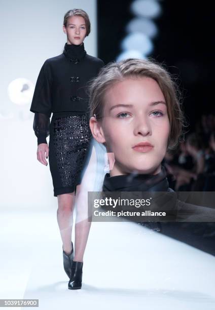 Models present a creation at the Rena Lange show during the Mercedes-Benz Fashion Week in Berlin, Germany, 17 January 2013. The presentations of the...