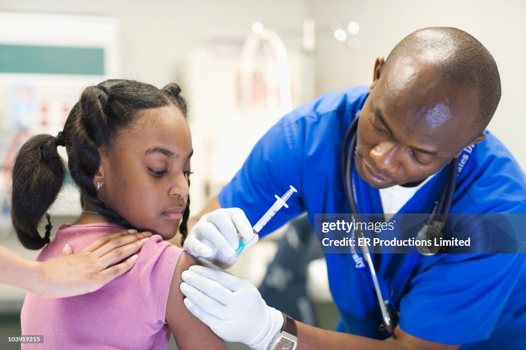 African American nurse giving patient injection