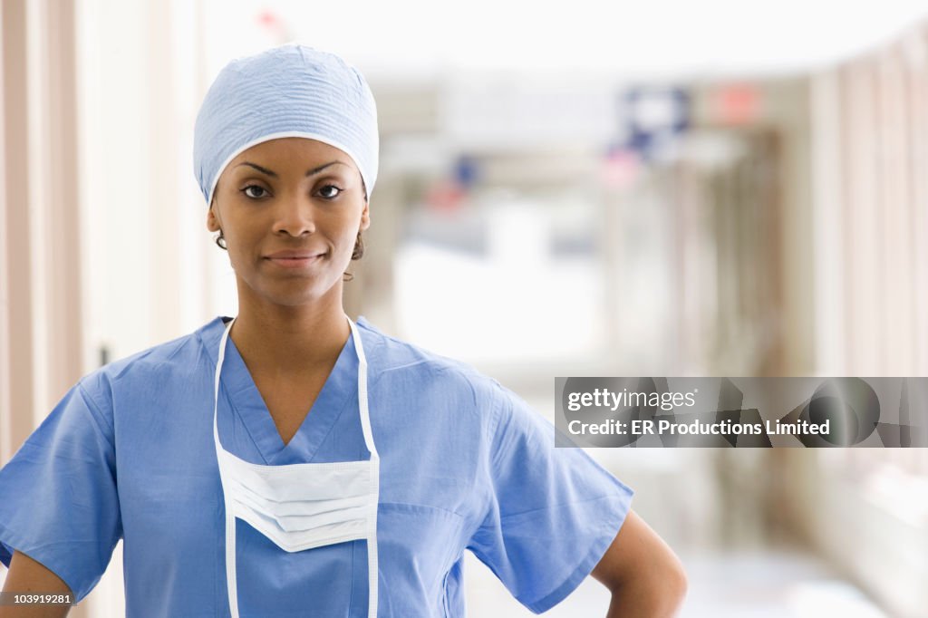 Confident Black surgeon in hospital corridor