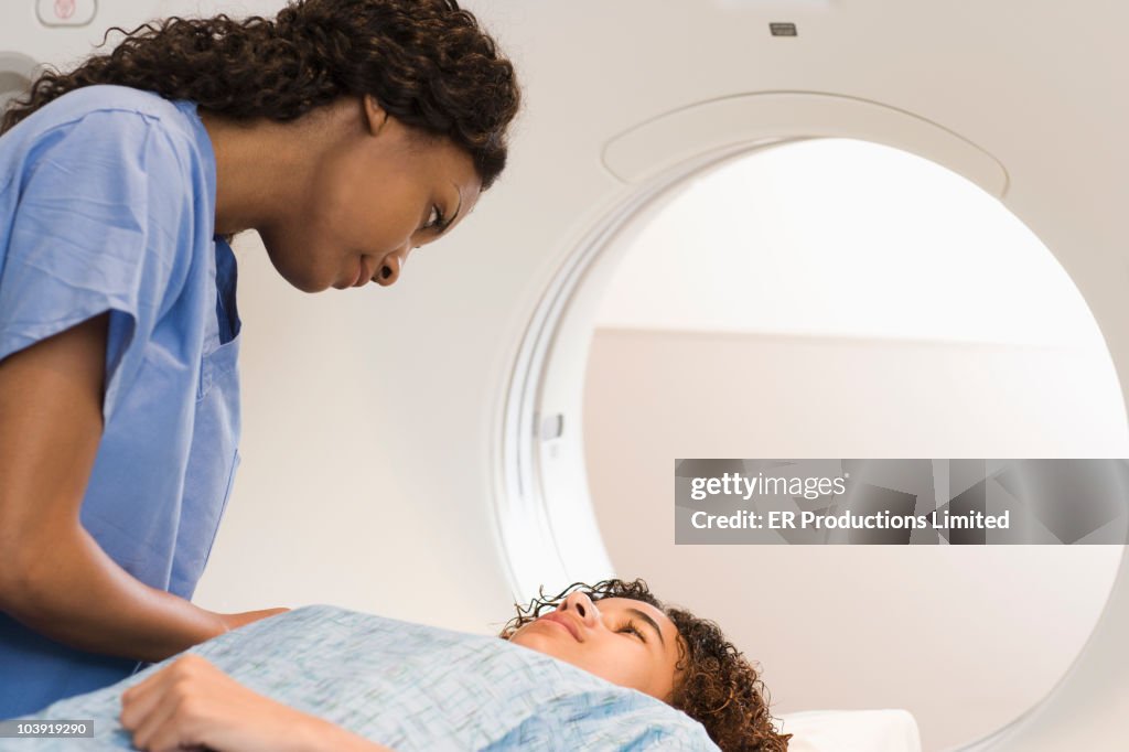 Doctor preparing patient for MRI