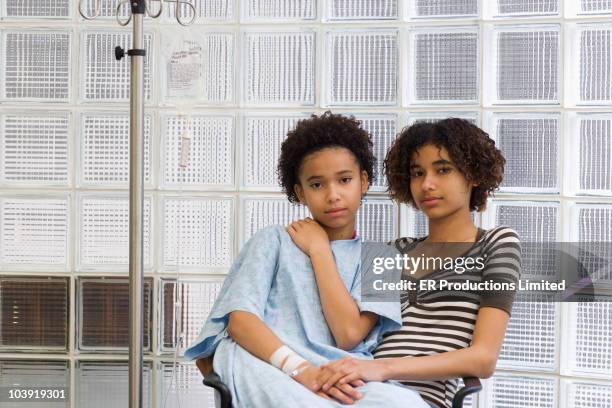 girl sitting with sister receiving iv - sibling hospital stock pictures, royalty-free photos & images