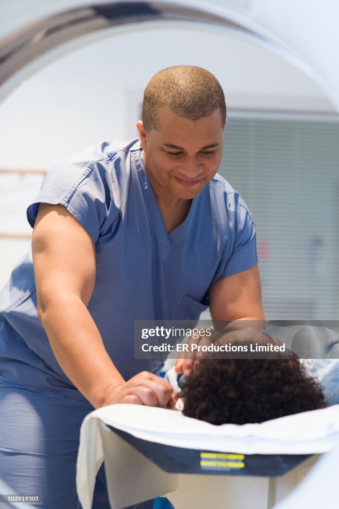 Doctor preparing patient for MRI